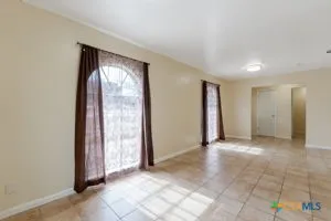 an empty room with windows and closet