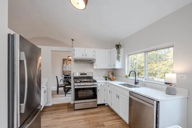 a bedroom with a large bed and a chandelier fan