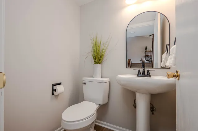 a view of a house with wooden deck and furniture