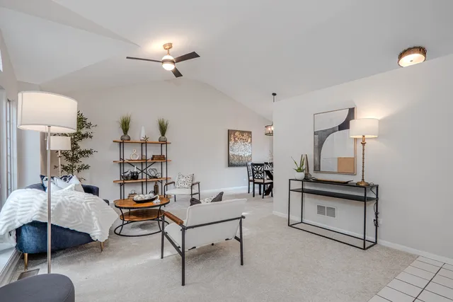 a kitchen with stainless steel appliances granite countertop a stove a sink dishwasher a dining table and chair with wooden floor