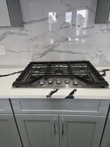 a close view of a stove a microwave and cabinets