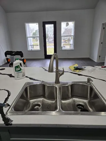 a kitchen that has a sink and a stove