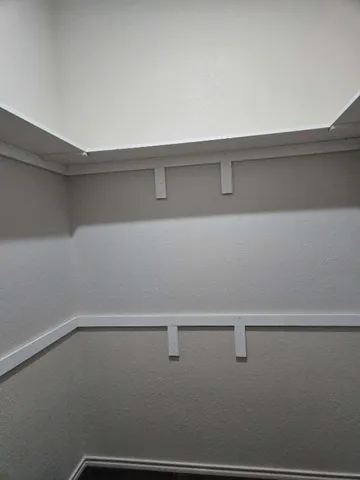 a view of a room with racks on the wall