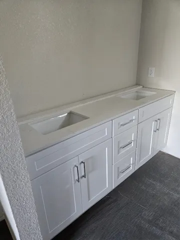a kitchen with white cabinets