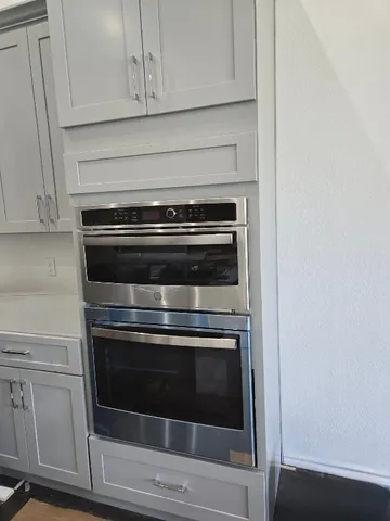 a stove top oven sitting inside of a kitchen