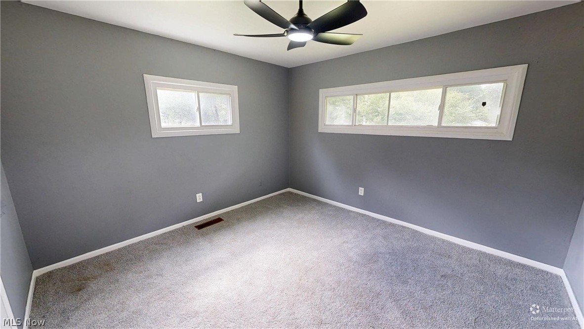 4174 Burkey Road Austintown, OH 44515 - Photo 11 of 33 Spacious room featuring neutral gray walls, light gray carpeting, and white baseboards