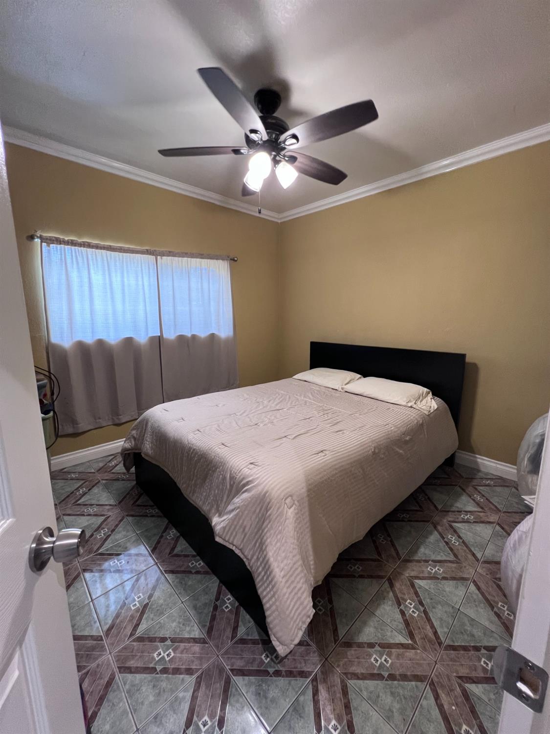 281 West Wilson Street Rialto, CA 92376 - Photo 11 of 15 a bedroom with a bed and window