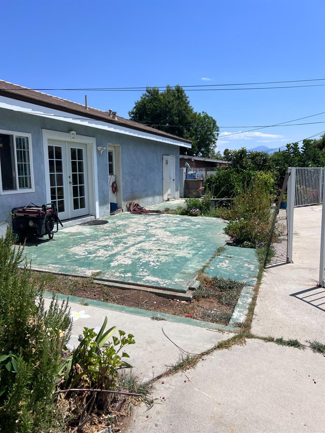 281 West Wilson Street Rialto, CA 92376 - Photo 13 of 15 a view of a house with a backyard and a garden