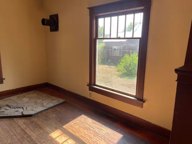 an empty room with windows and closet