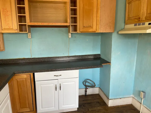 a kitchen with a sink and cabinets