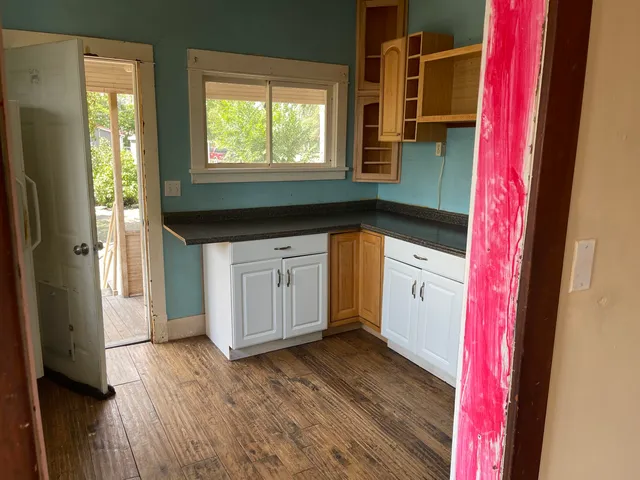 a bathroom with a granite countertop sink and a mirror
