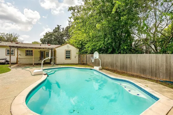 a view of house with outdoor space and swimming pool
