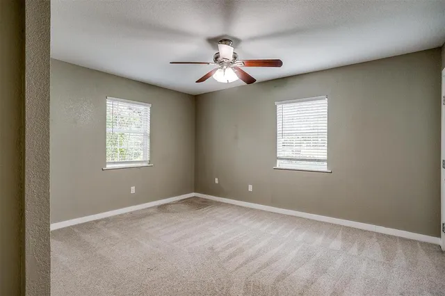 a kitchen with granite countertop white cabinets and a stove