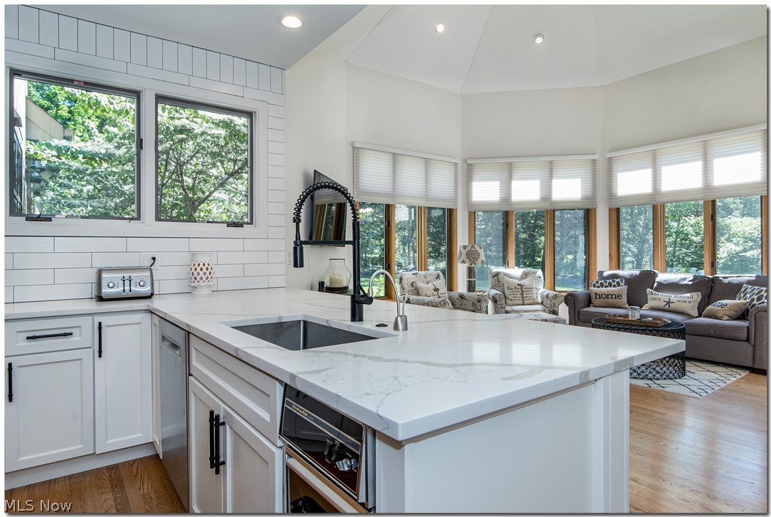 2569 Ginger Wren Road Cleveland, OH 44124 - Photo 10 of 35 MODERN STYLISH & FUNCTIONAL PENINSULA W/SQ EDGE UNDER-MOUNT SINK, MATT BLACK PRE-RINSE FAUCET, STATUARIO QUARTZ COUNTERTOPS, PURE WHITE CERAMIC SUBWAY BACKSPLASH, DISHWASHER & TRASH COMPACTOR.