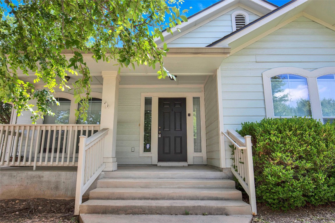 a front view of a house with plants