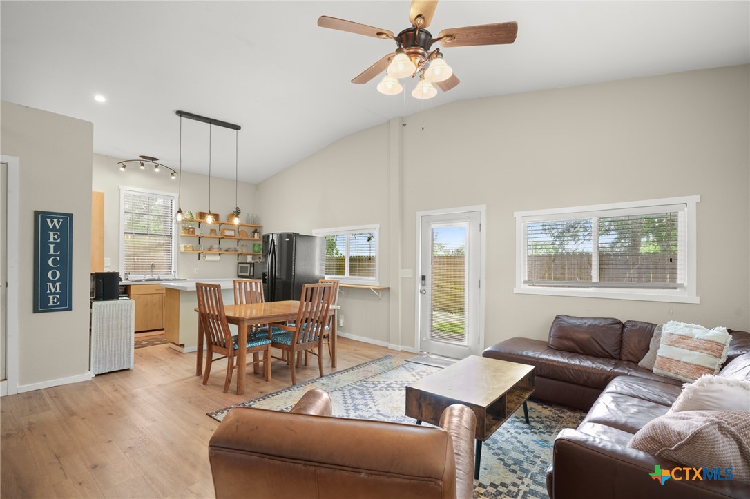 9725 Bock Road Buda, TX 78610 - Photo 29 of 37 Vaulted ceilings elevate this combined kitchen and living space, offering a comfortable gathering area.