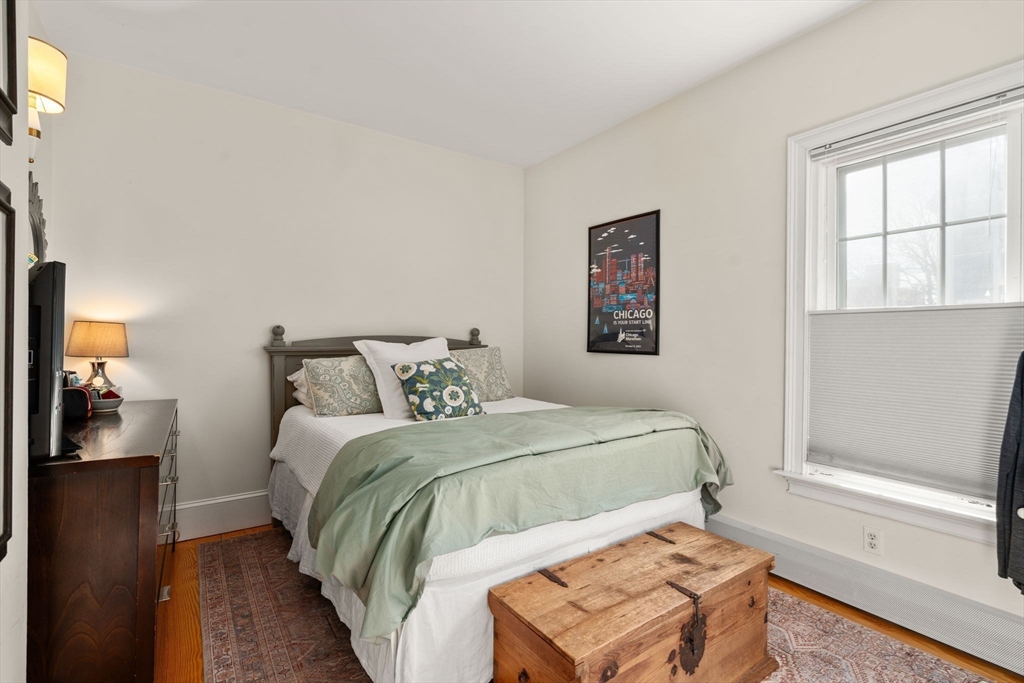 614 East 3rd Street, Unit 1 Boston, MA 02127 - Photo 11 of 23 a bedroom with a bed and wooden floor