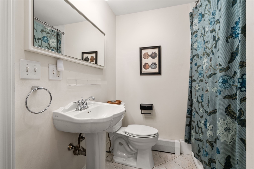 614 East 3rd Street, Unit 1 Boston, MA 02127 - Photo 13 of 23 a bathroom with a sink toilet and a mirror