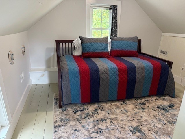428 Main Street Barnstable, MA 02635 - Photo 17 of 27 a bed sitting in a bedroom next to a window