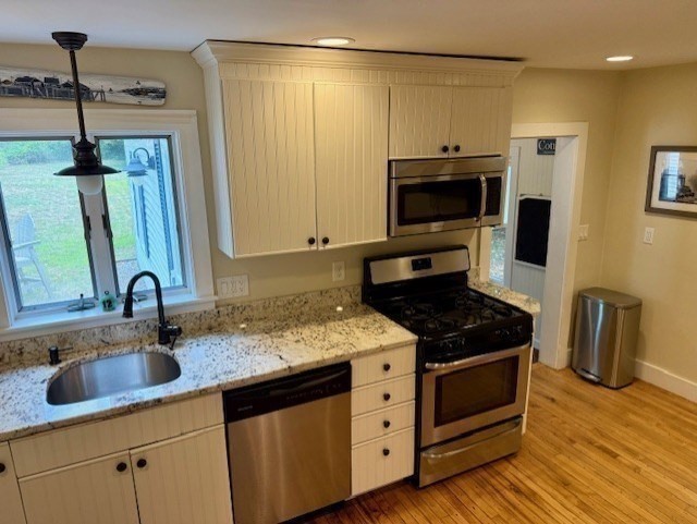 428 Main Street Barnstable, MA 02635 - Photo 7 of 27 a kitchen with granite countertop a sink and a stove top oven