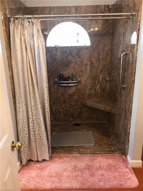 182 Ridge Drive Lexington, NC 27295 - Photo 15 of 31 Nice walk in shower with seat and grab bar. Dual vanities in bathroom.