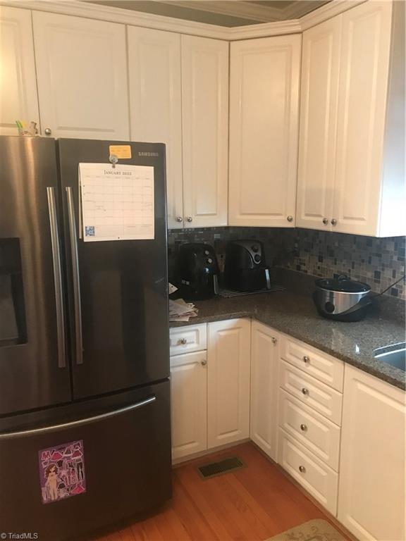 Stainless steel fridge and lots of cabinets!