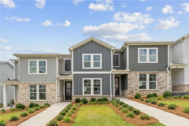 a front view of a house with a yard