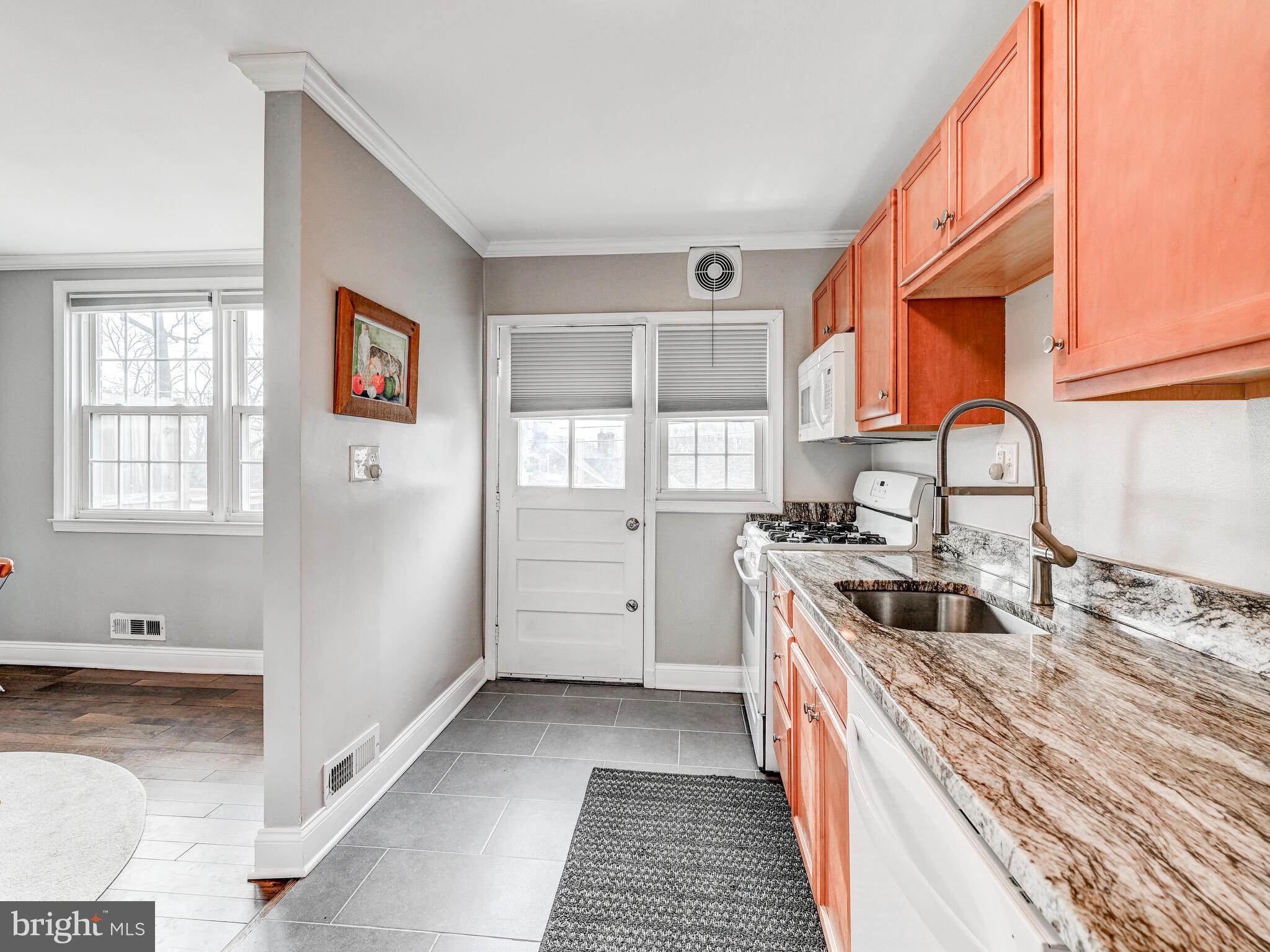 1507 Clearwood Road Parkville, MD 21234 - Photo 14 of 27 a kitchen with a sink stove top oven and cabinets