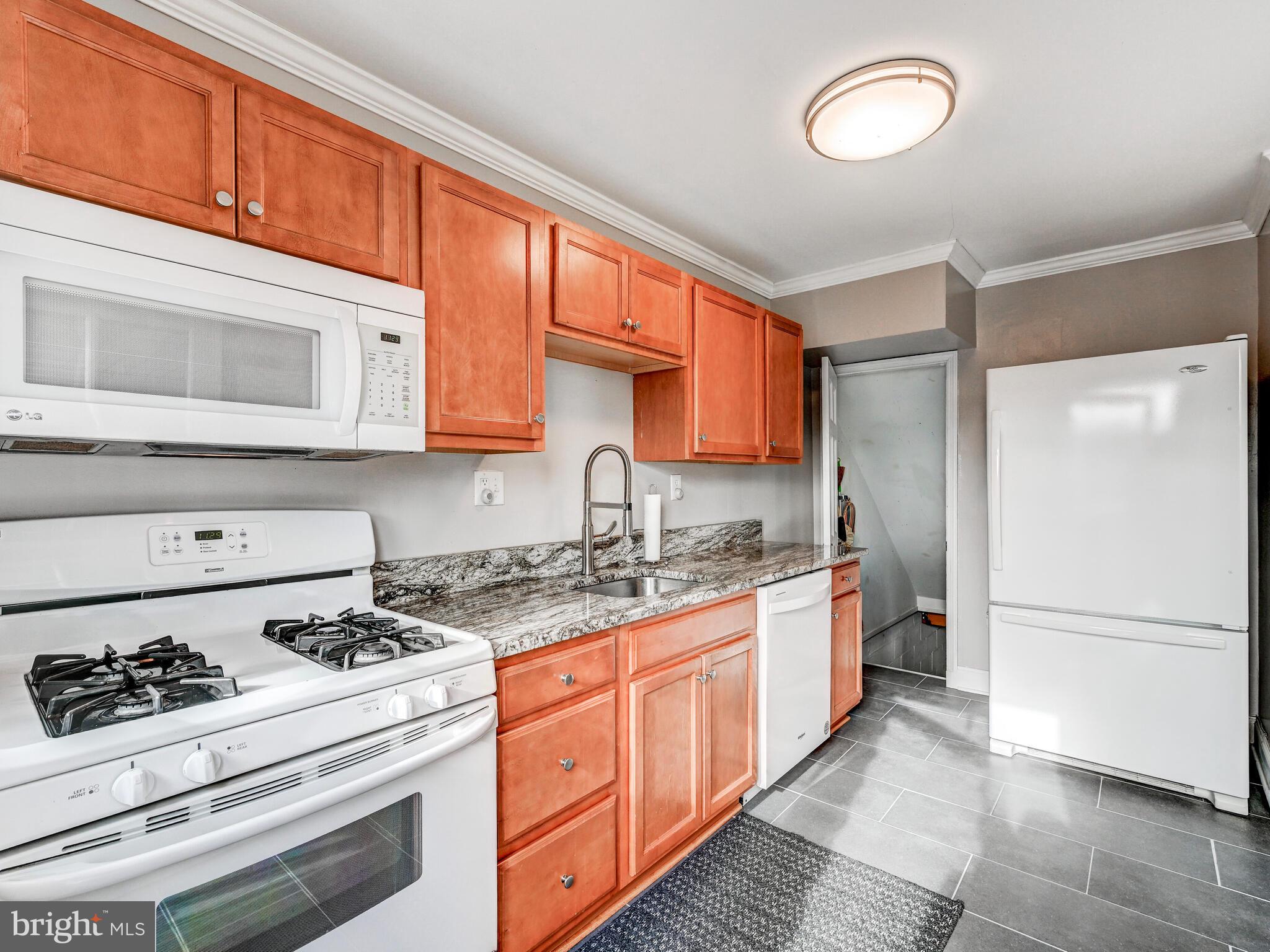 1507 Clearwood Road Parkville, MD 21234 - Photo 16 of 27 a kitchen with a stove a sink and a refrigerator