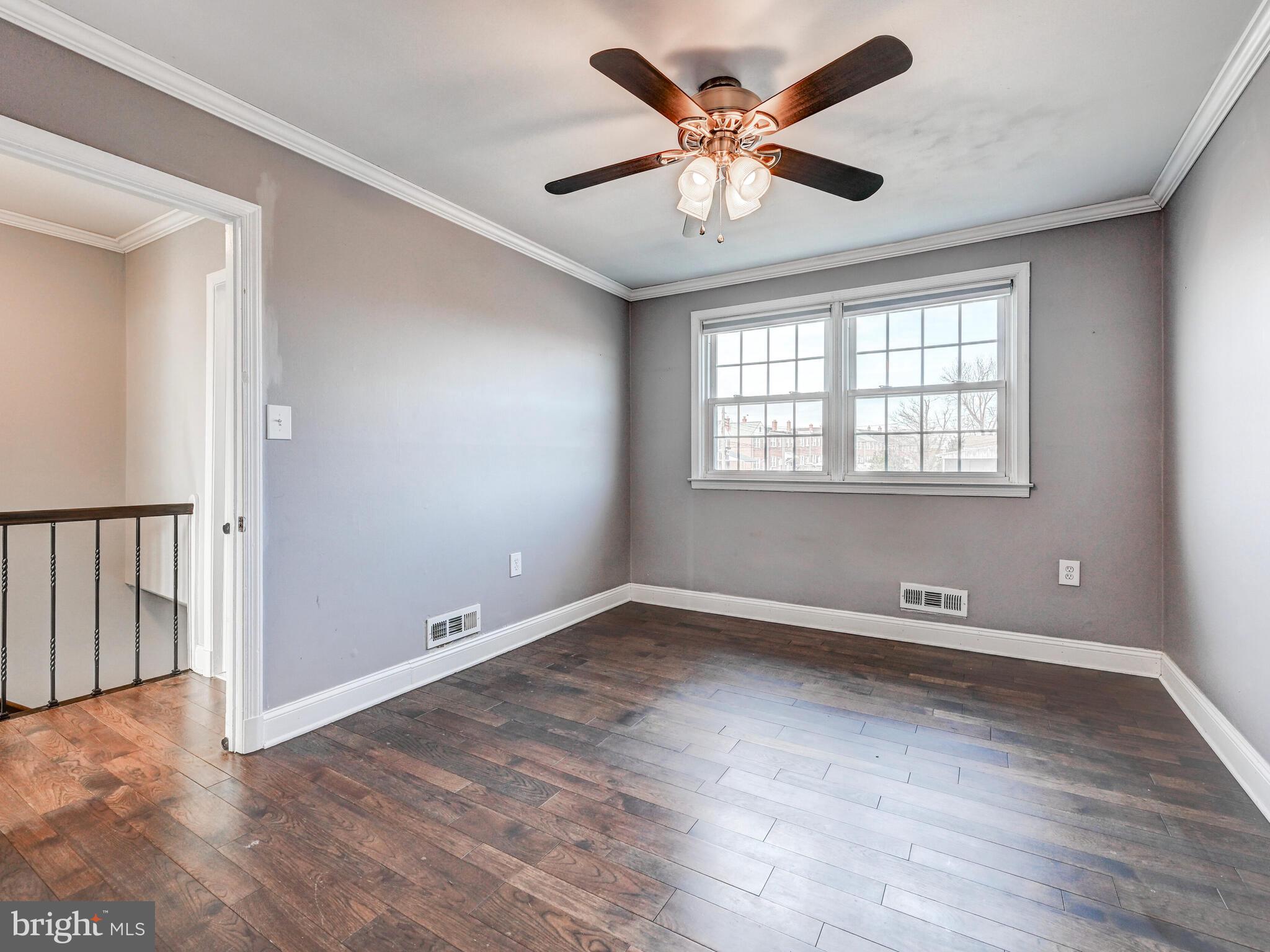 1507 Clearwood Road Parkville, MD 21234 - Photo 18 of 27 an empty room with wooden floor and windows