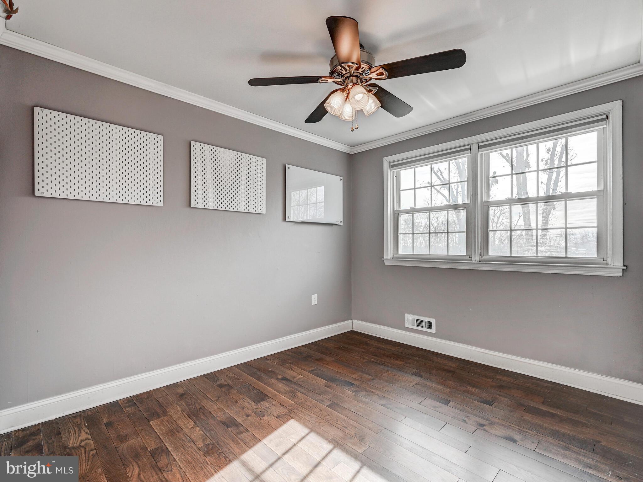 1507 Clearwood Road Parkville, MD 21234 - Photo 19 of 27 a view of empty room with wooden floor and fan
