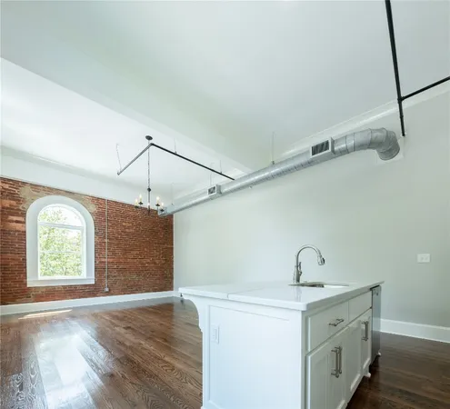 a view of a kitchen with a sink a window and appliances