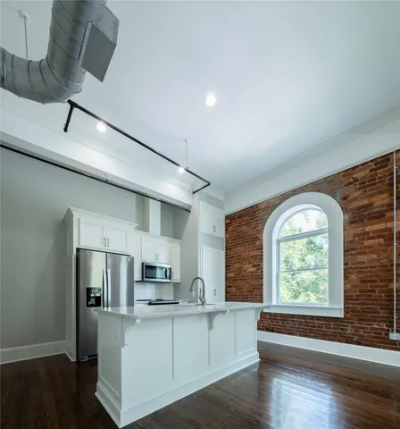 a kitchen with stainless steel appliances granite countertop a stove and a refrigerator
