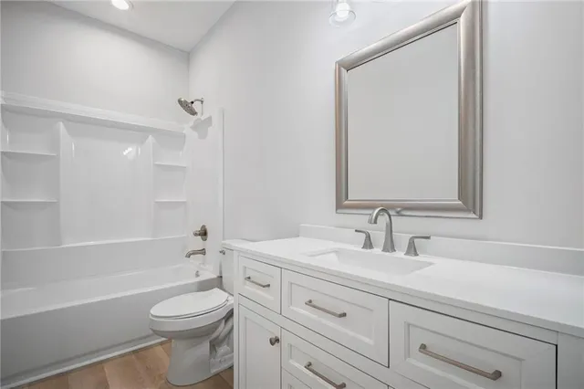 an empty room with window and ceiling fan