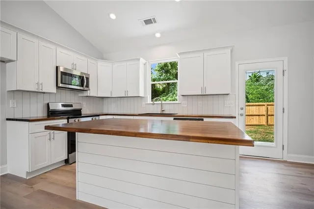 a kitchen with granite countertop a sink and a stove top oven