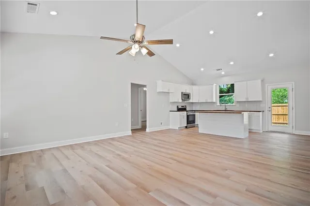 a view of kitchen with granite countertop cabinets and stainless steel appliances