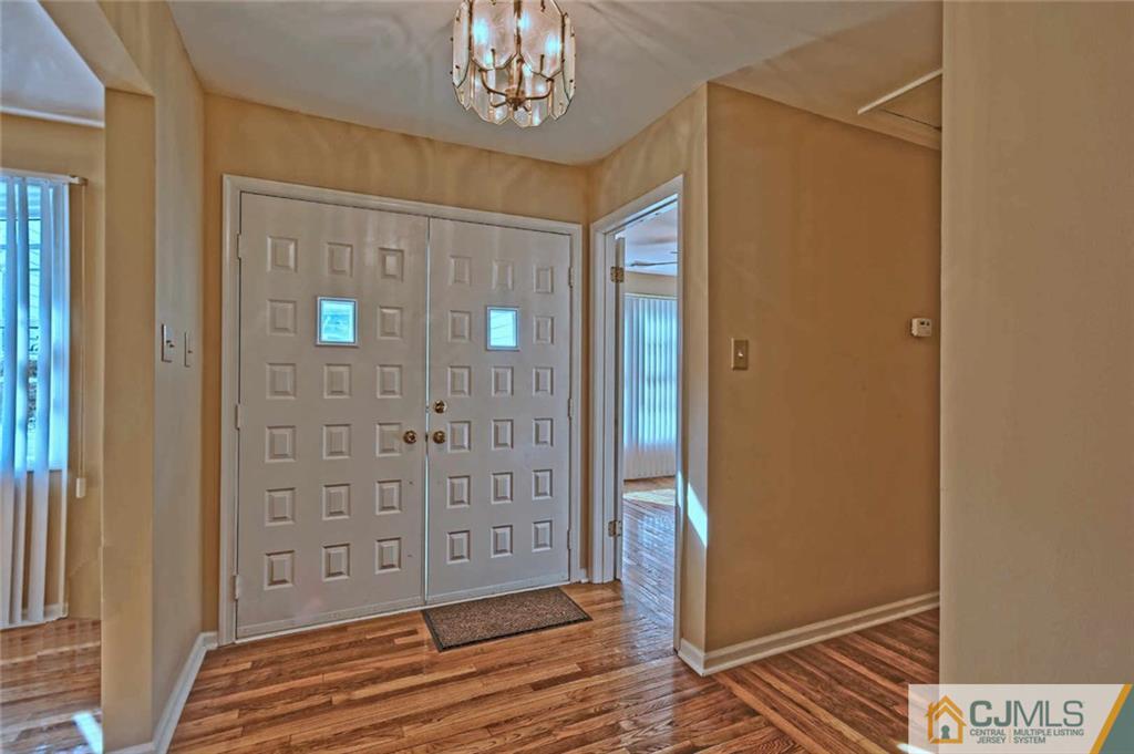 107 Brick Road Cherry Hill, NJ 08003 - Photo 3 of 18 wooden floor and windows in an empty room