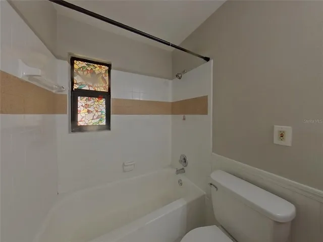 a bathroom with a toilet and a bathtub