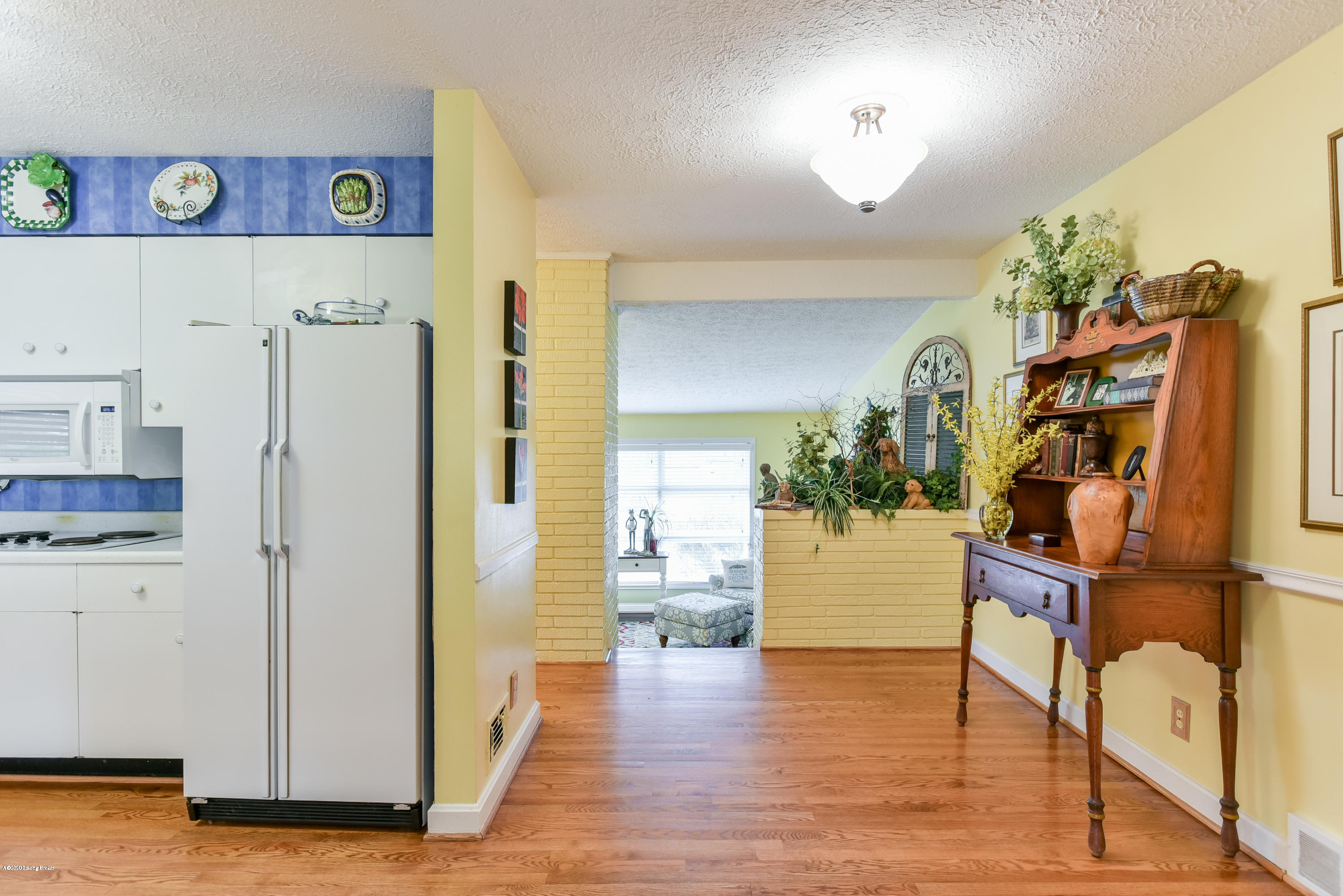 The kitchen provides ample white cabinetry and plenty of counter space