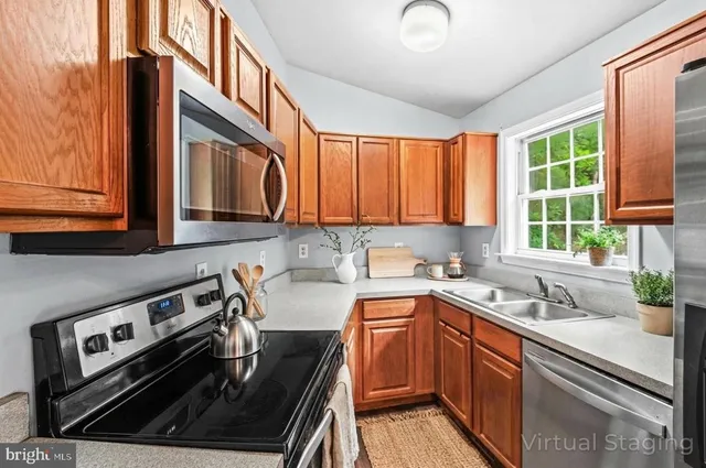 a kitchen that has a sink a stove and window