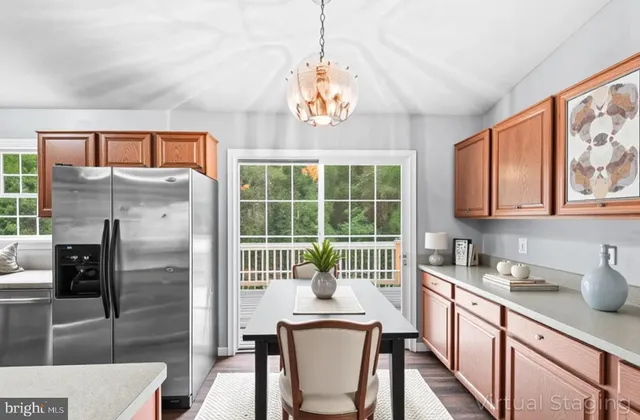 a kitchen with stainless steel appliances granite countertop a refrigerator a sink a stove and island