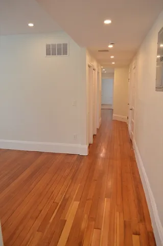 a view of a room with wooden floor and staircase