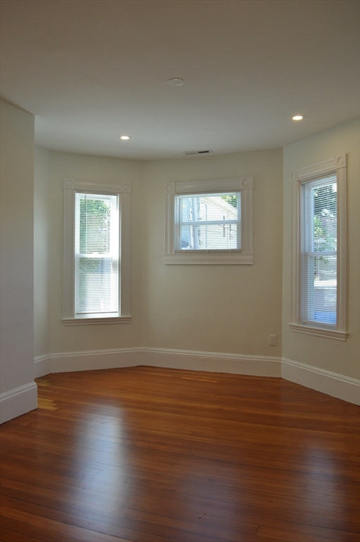 374 A Centre Street, Unit 3 Boston, MA 02130 - Photo 7 of 11 a view of an empty room with wooden floor and a window