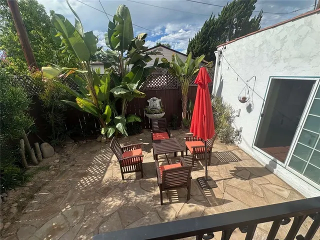 a bedroom with a bed wooden floor and a television