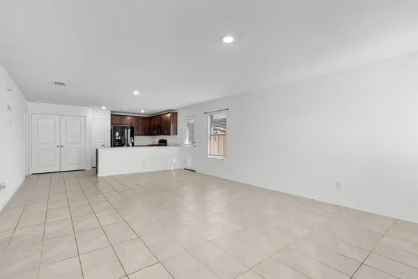 a view of a kitchen with a sink and white cabinets