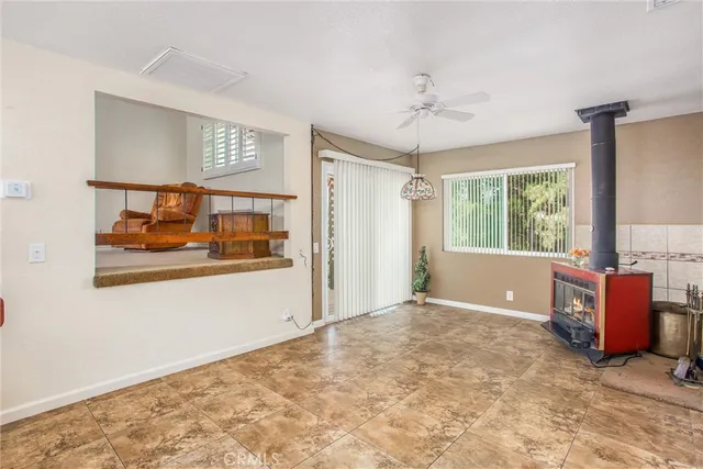an empty room with windows and cabinet
