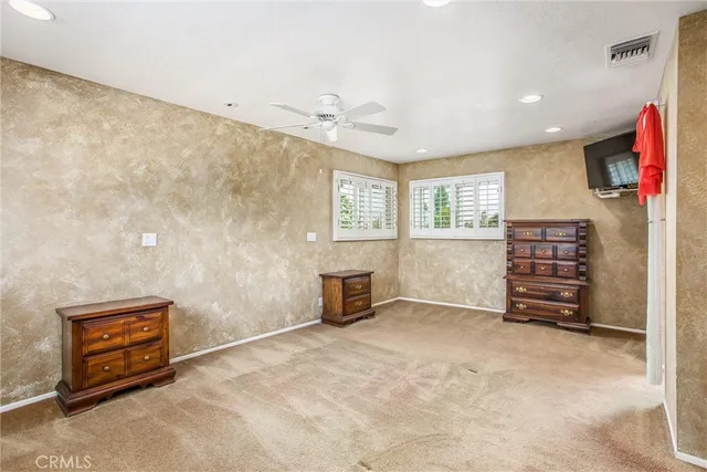 an empty room with furniture and a window
