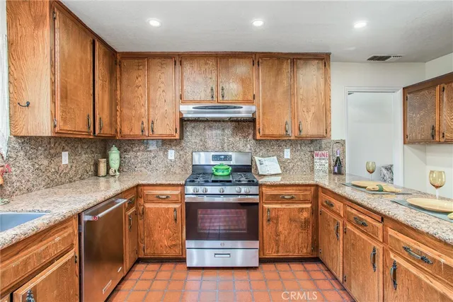 a kitchen with a sink stove and cabinets