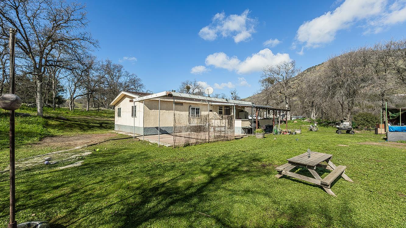 1321 Elwood Road Squaw Valley, CA 93675 - Photo 8 of 31 a view of a house with backyard and a garden