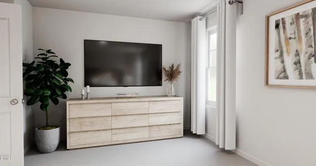 a living room with a flat screen tv and potted plant